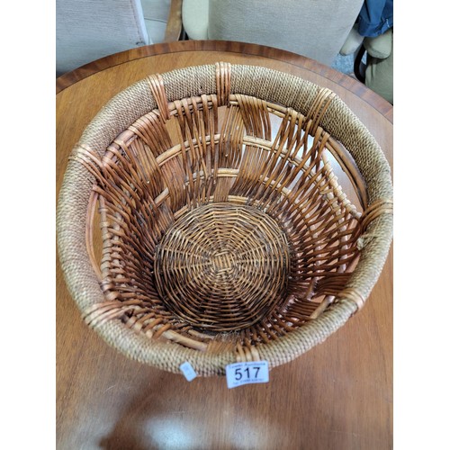 517 - Wicker woven basket with rope wound rim in tidy condition its diameter 38cm