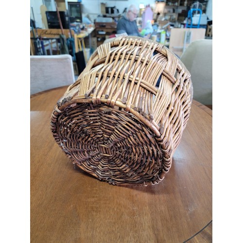 517 - Wicker woven basket with rope wound rim in tidy condition its diameter 38cm