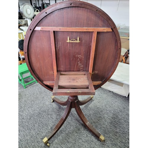 520 - Round Edwardian tilting top mahogany dining table with fine inlay to out rim, on for legs with brass... 