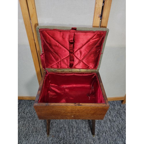 529 - Mahogany sewing stool box on legs with green dralon padded top and red lining.