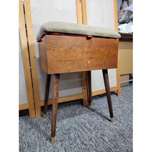 529 - Mahogany sewing stool box on legs with green dralon padded top and red lining.