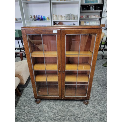 531 - Mahogany glazed bookcase with two leaded doors three tiers 105cm high 76cm wide and 21cm deep giving... 