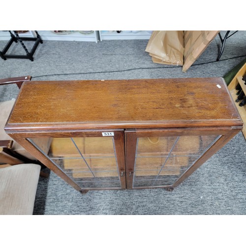 531 - Mahogany glazed bookcase with two leaded doors three tiers 105cm high 76cm wide and 21cm deep giving... 