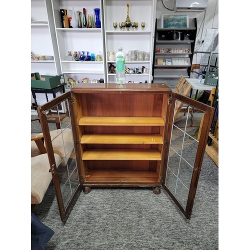 531 - Mahogany glazed bookcase with two leaded doors three tiers 105cm high 76cm wide and 21cm deep giving... 