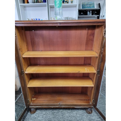 531 - Mahogany glazed bookcase with two leaded doors three tiers 105cm high 76cm wide and 21cm deep giving... 