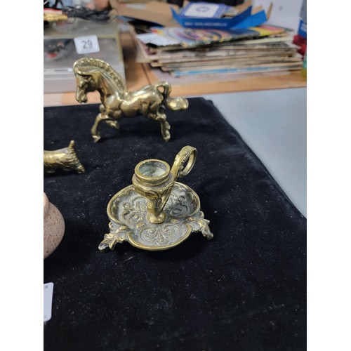 338 - A brass owl a brass horse at walk a brass horse lying down a brass dog a candle holder and a small c... 