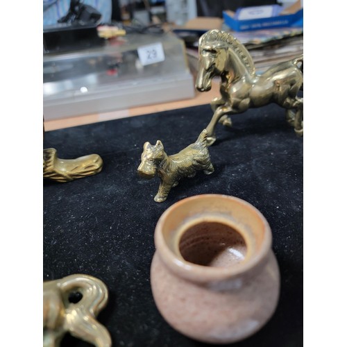 338 - A brass owl a brass horse at walk a brass horse lying down a brass dog a candle holder and a small c... 