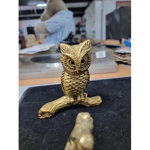 338 - A brass owl a brass horse at walk a brass horse lying down a brass dog a candle holder and a small c... 