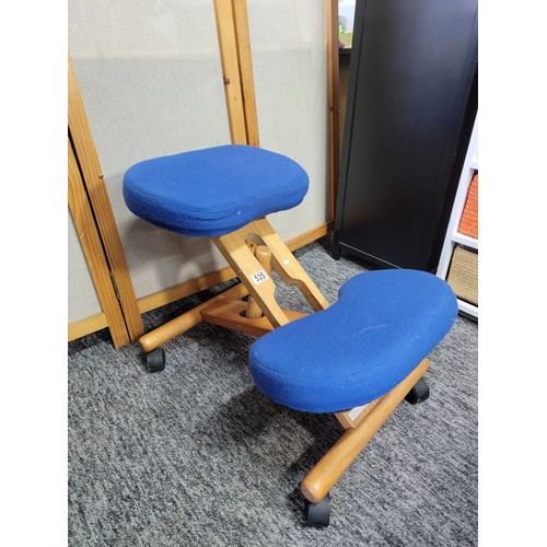 535 - Blue upholstered kneeling stool to promote good posture on castors