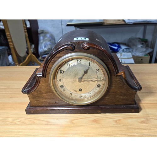 174 - An antique mantel clock with a mahogany case featuring a good quality Garrard England movement, with... 