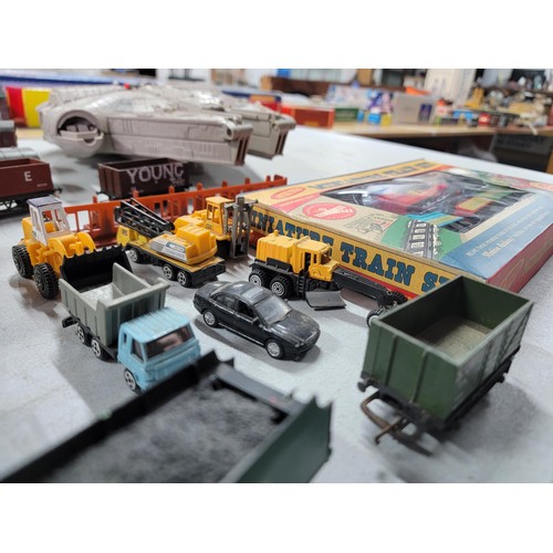 75 - A box containing a quantity of model train items including carriages, wagons, buildings, platforms, ... 