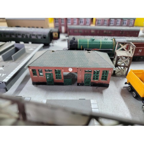 75 - A box containing a quantity of model train items including carriages, wagons, buildings, platforms, ... 