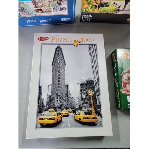 77 - A collection of 5x jigsaw puzzles, 3 are 1000 piece of various subjects, along with a The City Frans... 