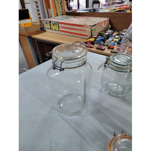 82 - A collection of 12 storage jars and 1 flip top bottle to include Kilner jars etc.