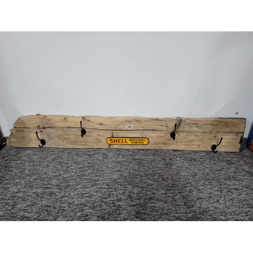 102 - Large piece of drift wood converted to a coat rack with 4x hooks along with a cast iron Shell sign, ... 