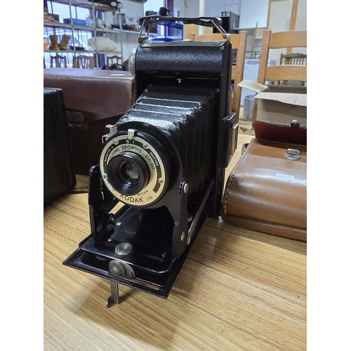 1 - A collection of 4x vintage cameras to include a Kodak brownie six-20, a Balda front box, along with ... 