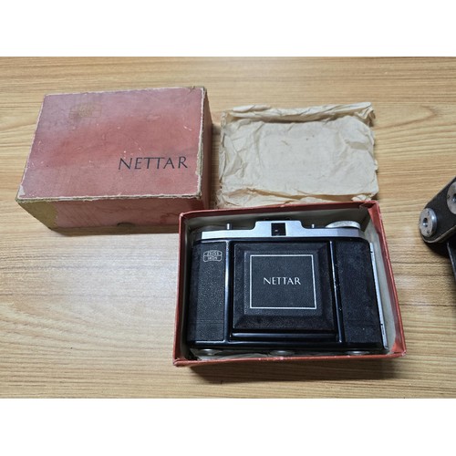 3 - A quantity of cameras to include a good vintage Zeiss Ikon Nettar folding camera with its original b... 