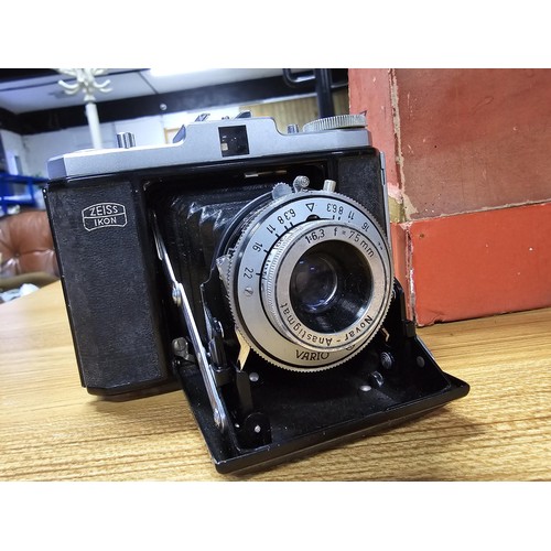 3 - A quantity of cameras to include a good vintage Zeiss Ikon Nettar folding camera with its original b... 