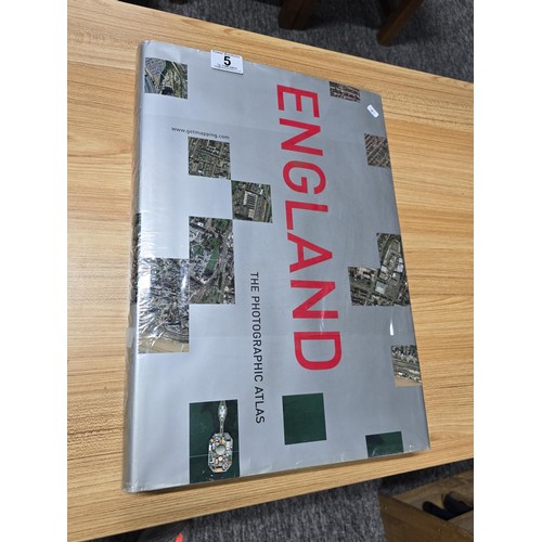 5 - A large book titled England the photographic atlas by Get Mapping.com containing a very large quanti... 