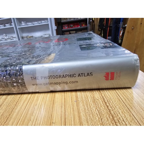 5 - A large book titled England the photographic atlas by Get Mapping.com containing a very large quanti... 