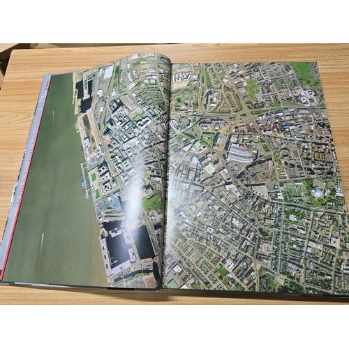 5 - A large book titled England the photographic atlas by Get Mapping.com containing a very large quanti... 