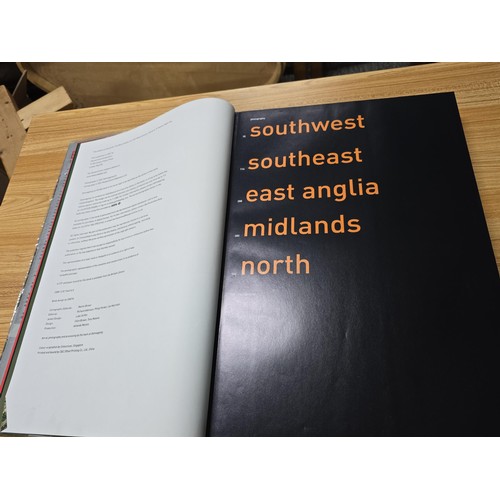 5 - A large book titled England the photographic atlas by Get Mapping.com containing a very large quanti... 