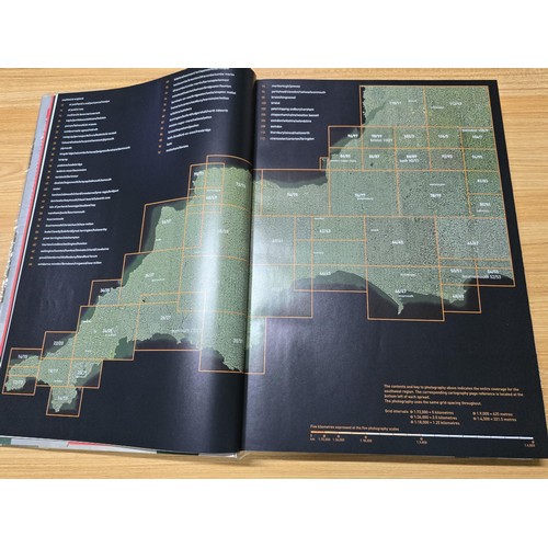 5 - A large book titled England the photographic atlas by Get Mapping.com containing a very large quanti... 