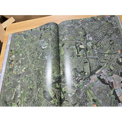 5 - A large book titled England the photographic atlas by Get Mapping.com containing a very large quanti... 