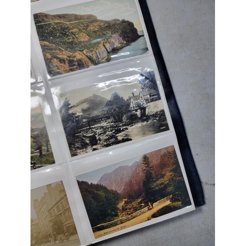 124 - Large blue album containing 250 north wales Antique postcards inc Rhos on sea, Lllangollen, Bettws -... 