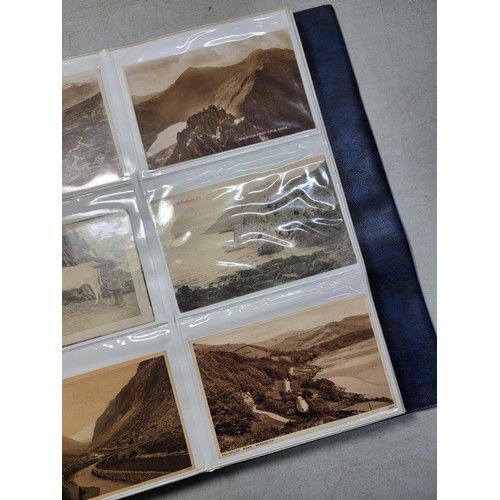 124 - Large blue album containing 250 north wales Antique postcards inc Rhos on sea, Lllangollen, Bettws -... 