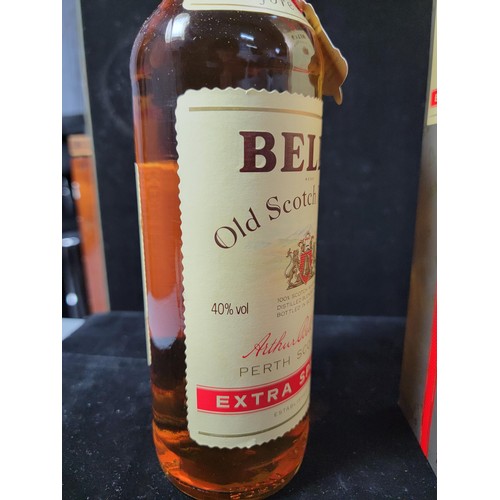 129 - Boxed vintage 1980's new and sealed bottle of Bells Whisky Extra Special complete with red string an... 