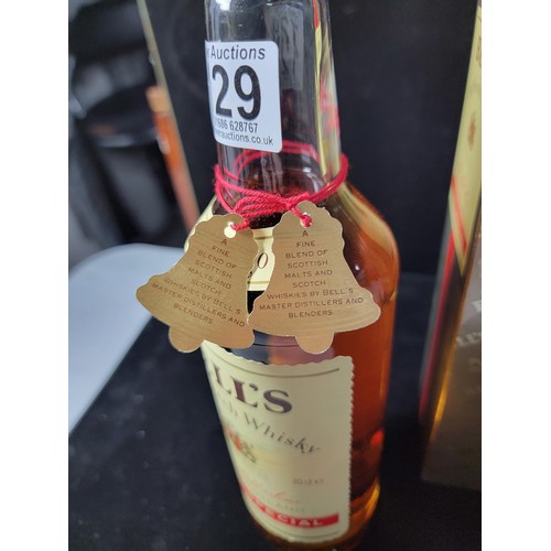 129 - Boxed vintage 1980's new and sealed bottle of Bells Whisky Extra Special complete with red string an... 