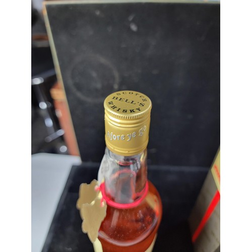 129 - Boxed vintage 1980's new and sealed bottle of Bells Whisky Extra Special complete with red string an... 