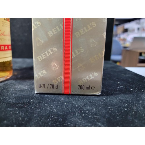 129 - Boxed vintage 1980's new and sealed bottle of Bells Whisky Extra Special complete with red string an... 