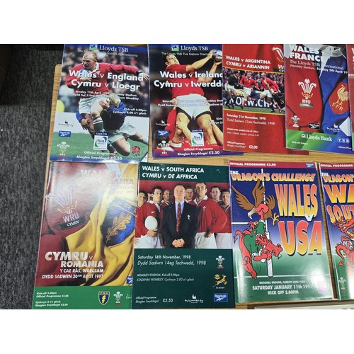 72 - A large collection of Rugby programmes along with a complete The Sun encyclopedia and soccer stamp a... 