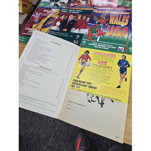 72 - A large collection of Rugby programmes along with a complete The Sun encyclopedia and soccer stamp a... 