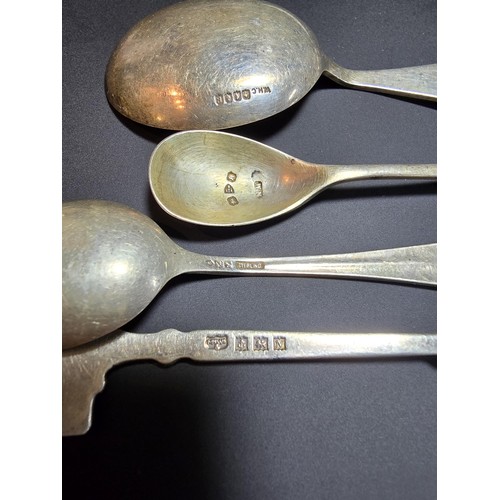 180 - A collection of 4x hallmarked silver spoons and white metal pickle fork. To include 3 silver spoons ... 