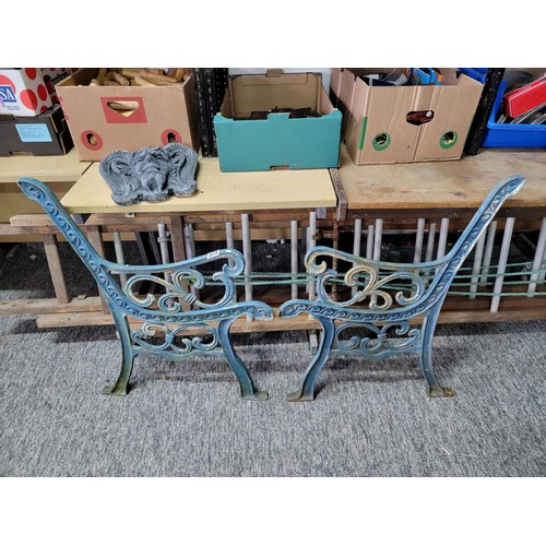 373 - Pair of cast iron ornate bench ends painted in blue, measure 81cm high 52cm wide