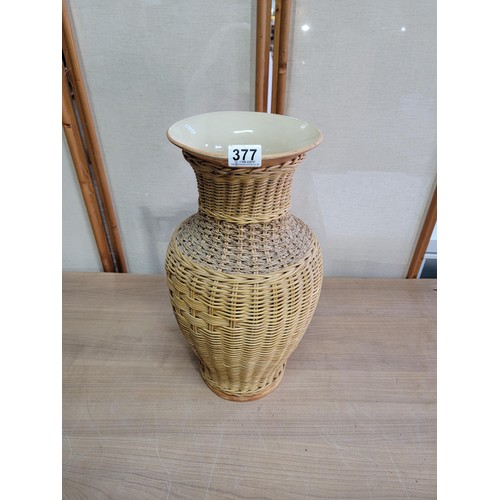 378 - Large ceramic vase with wicker casing, vase has an old repair to the lip stands at 53cm high diamete... 