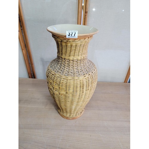 378 - Large ceramic vase with wicker casing, vase has an old repair to the lip stands at 53cm high diamete... 