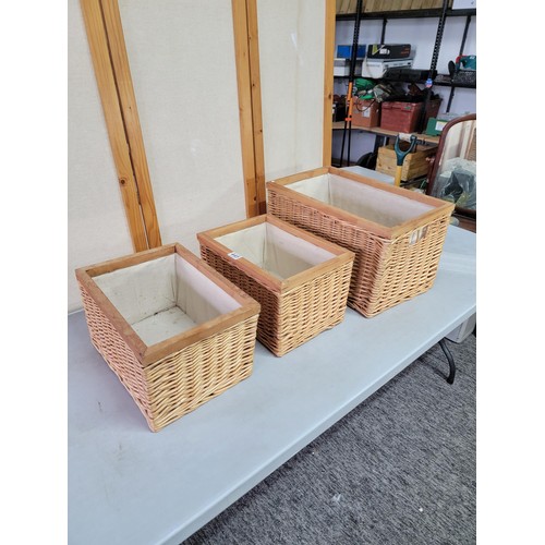 445 - 3x wicker framed lined laundry baskets largest measures 31cm high, 54cm long, 33cm wide