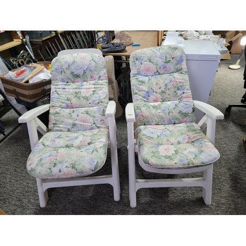 455 - 2x white plastic recliner garden chairs complete with floral cushions in overall good condition fold... 