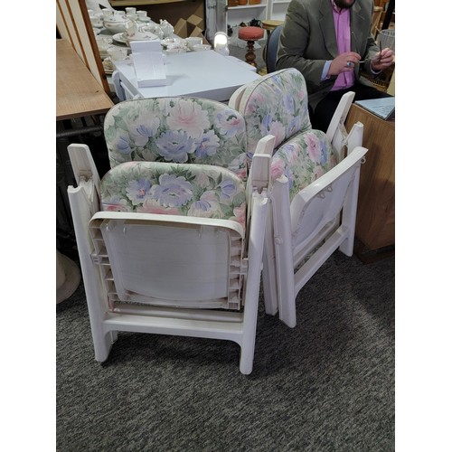 455 - 2x white plastic recliner garden chairs complete with floral cushions in overall good condition fold... 