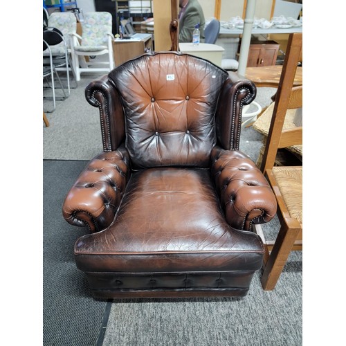 458 - Good quality brown leather wing back Chesterfield style button back and button arm chair, studded to... 