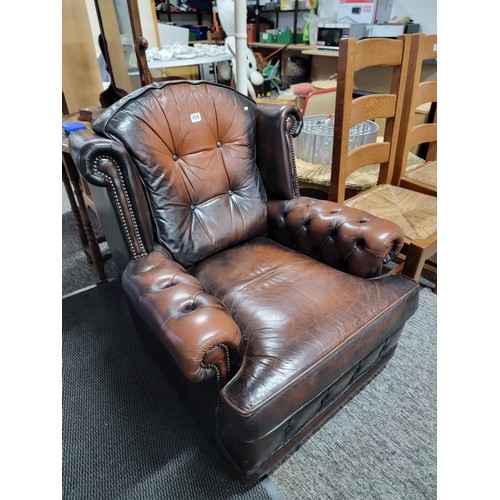 458 - Good quality brown leather wing back Chesterfield style button back and button arm chair, studded to... 