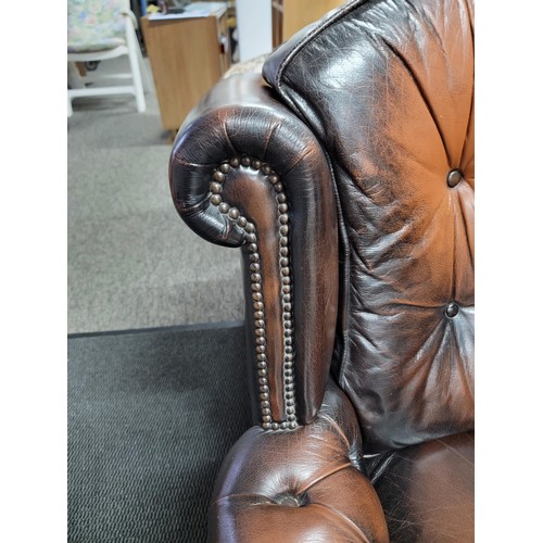 458 - Good quality brown leather wing back Chesterfield style button back and button arm chair, studded to... 