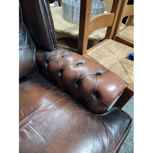 458 - Good quality brown leather wing back Chesterfield style button back and button arm chair, studded to... 