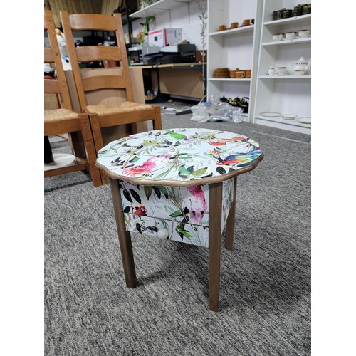 462 - Circular top sewing table with yellow lining drawer to the base has been decorated with bird design ... 