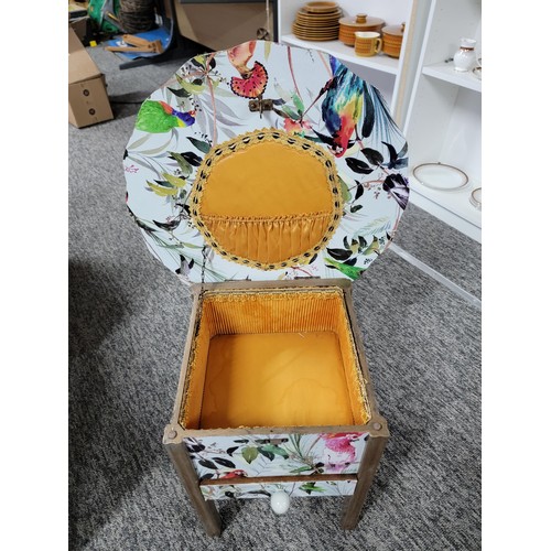 462 - Circular top sewing table with yellow lining drawer to the base has been decorated with bird design ... 