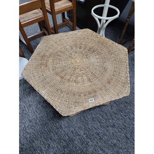 468 - Large hexagonal wicker table with galleried shelf to the base in overall good condition stands at 40... 